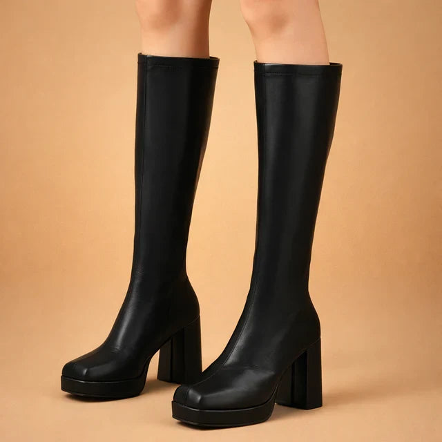 Stylish women's black platform over-the-knee boots with a chunky heel, perfect for winter fashion.