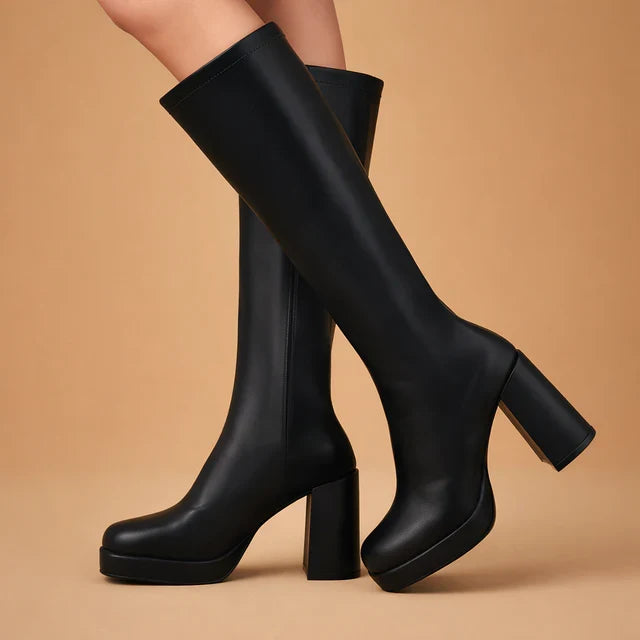Chic women's black platform over-the-knee boots, offering stylish footwear for winter outfits.