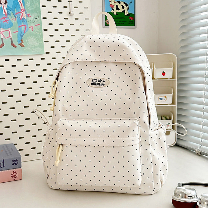 Spacious black polka dot backpack interior with multiple compartments for organized daily essentials, school, or work.
