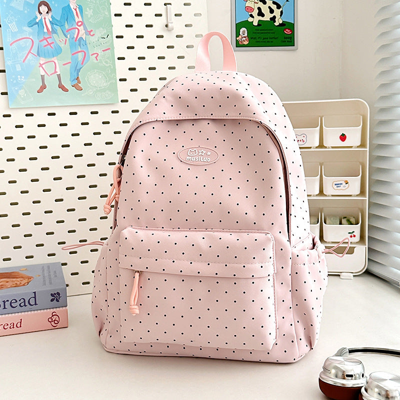 Durable women's polka dot backpack, black with white dots, featuring comfortable straps for school, work, or travel.