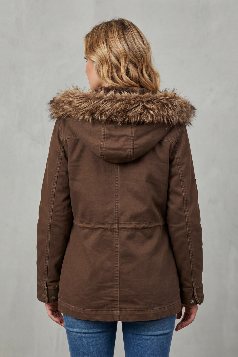 Essential women's brown parka jacket featuring faux fur hood for ultimate warmth & winter style.
