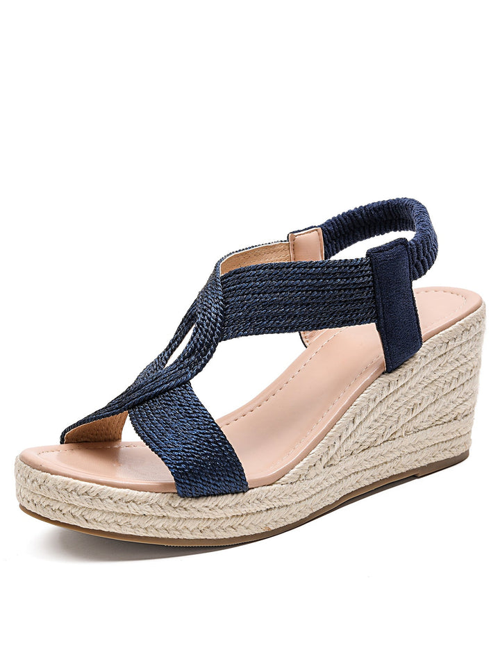 Women's elegant criss-cross platform wedge sandals with open toe design for sophisticated summer style.