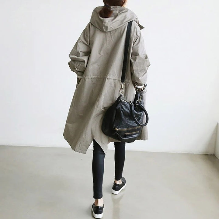 Elegant women's hooded A-line long rain jacket, a stylish & lightweight outerwear choice for spring & fall.