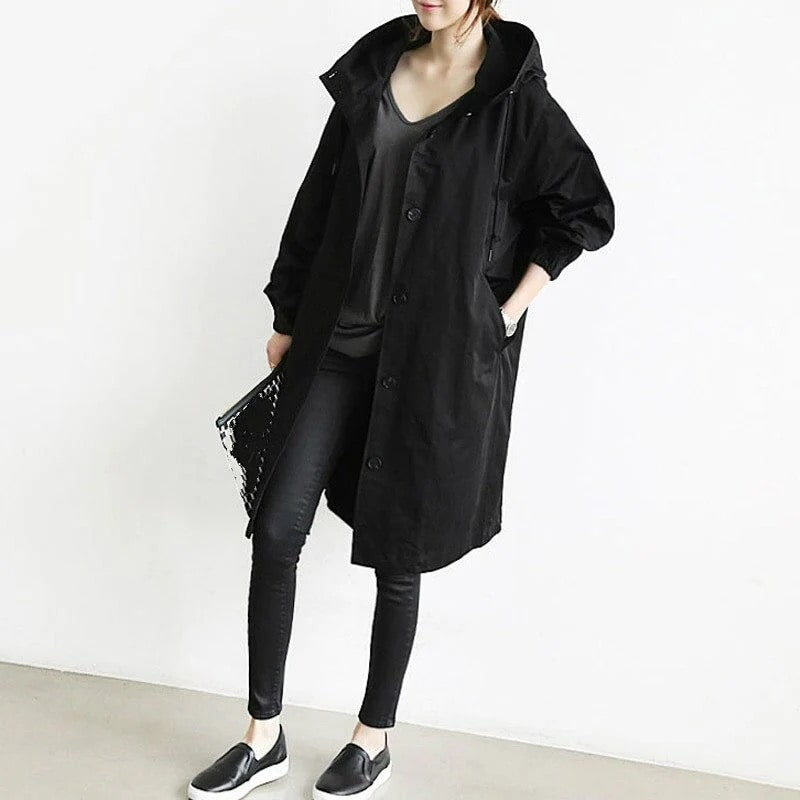 Fashionable women's long rain jacket, A-line silhouette with hood, providing waterproof & stylish all-weather coverage.