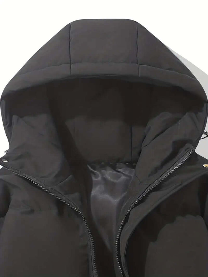 Close-up of the hood on a women's stylish puffer jacket. Warm winter outerwear for cold weather protection.