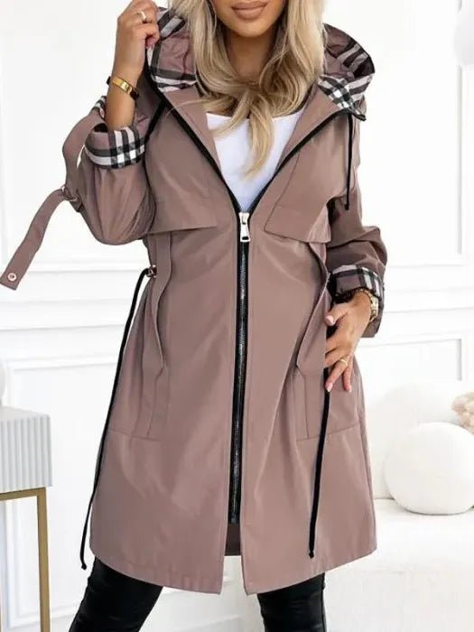 Stylish women's hooded waterproof trench coat with zip closure & drawstring waist. Perfect midi length rain jacket for fall.