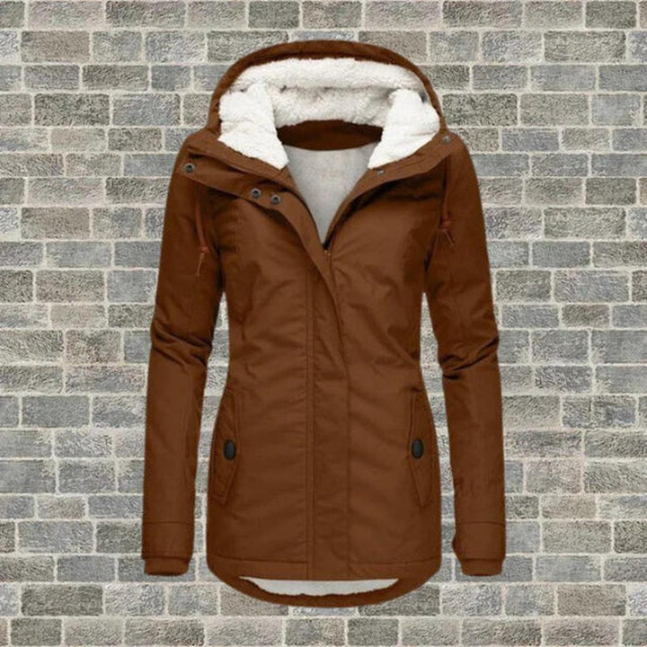 Warm women's hooded winter coat featuring a durable design. Excellent cold weather gear with pockets for daily use.