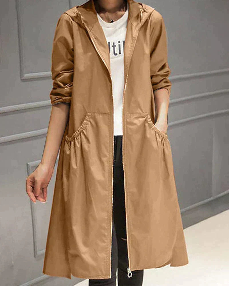 Versatile women's waterproof hooded jacket, knee-length for comprehensive rain protection & outerwear.