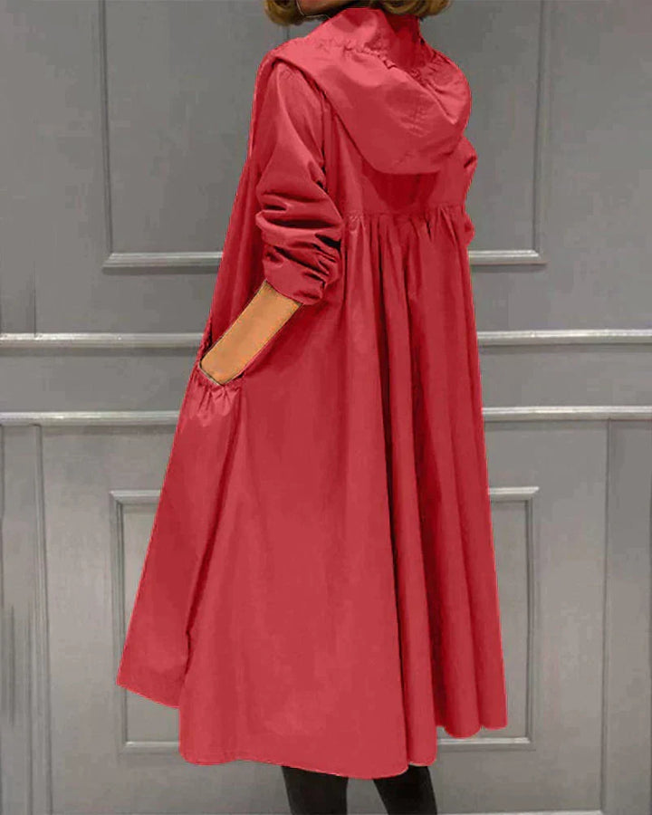 Women's hooded waterproof raincoat, knee-length & relaxed fit, great for active outdoor and casual wear.