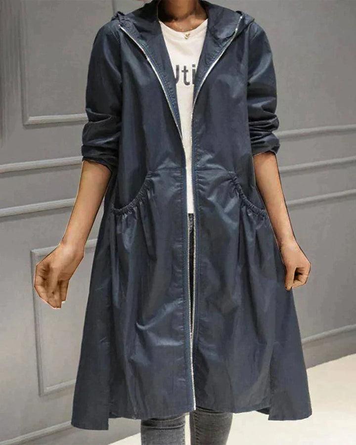 Elegant women's knee-length hooded waterproof jacket, an essential stylish and versatile all-weather raincoat.