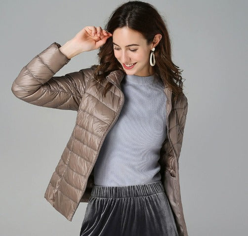 Women's warm quilted long-sleeve puffer jacket. Fashionable winter coat offering cozy comfort and style.