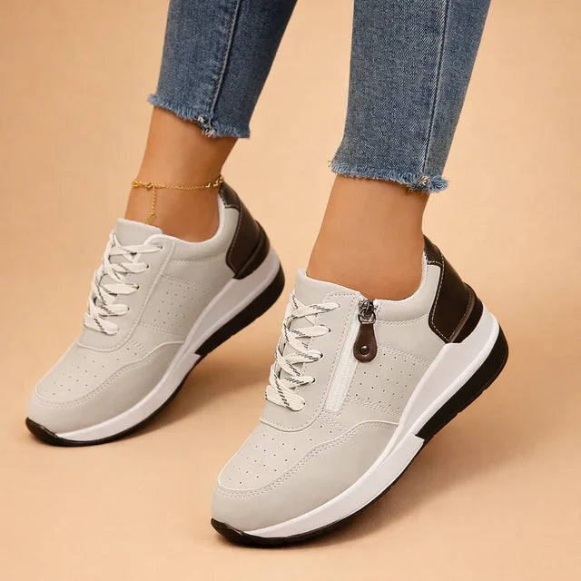 Stylish women's low-top sneakers with perforated design & cushioning for ultimate comfort & everyday wear.