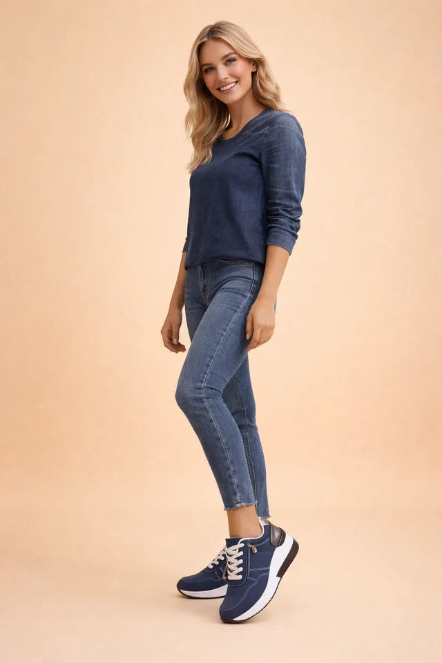 Textured women's low-top sneakers, featuring perforated design & cushioned insoles for breathability & all-day comfort.