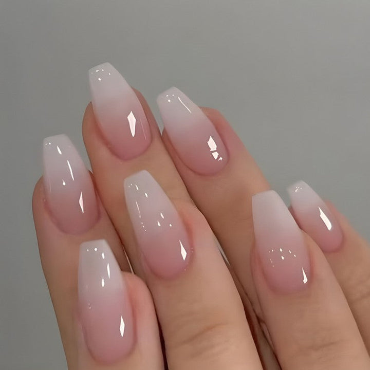 Stylish women's ombre press-on nails featuring a beautiful pink and white gradient for a chic salon look.