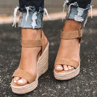 Comfortable women's open toe wedge sandals. Stylish spring footwear with elegant design for casual or day wear.