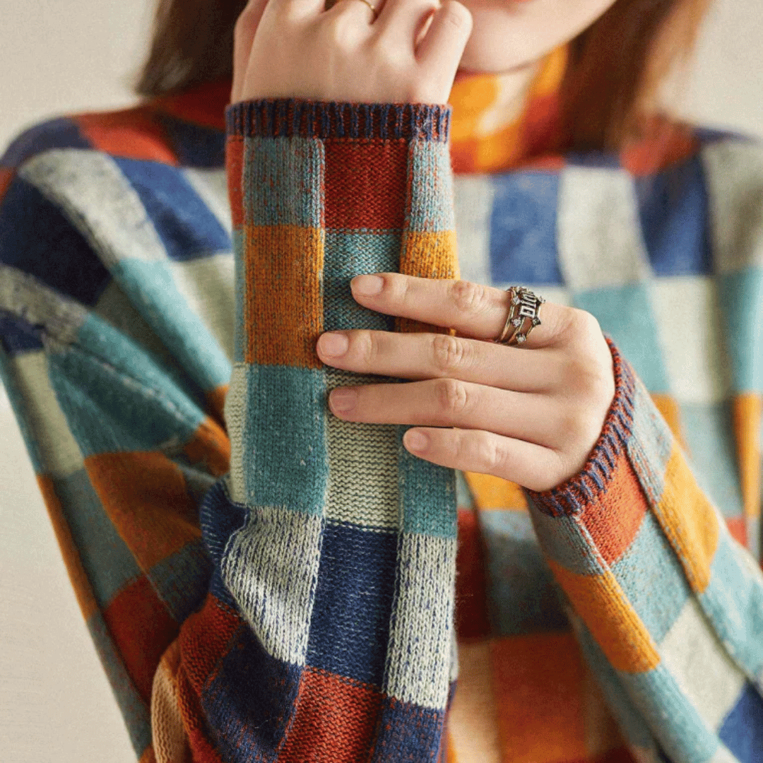 Cozy knit orange patchwork turtleneck sweater for women, featuring a stylish design ideal for elegant winter wear.