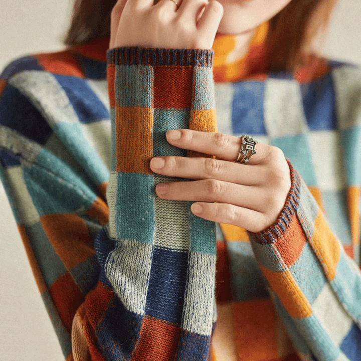 Cozy knit orange patchwork turtleneck sweater for women, featuring a stylish design ideal for elegant winter wear.