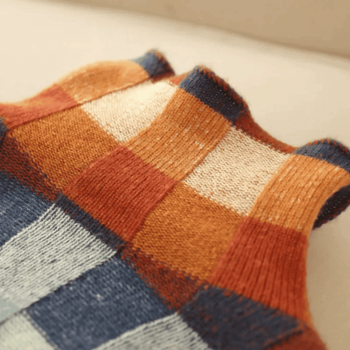 Unique patchwork turtleneck sweater for women in orange, a cozy and stylish long-sleeve knit perfect for winter fashion.