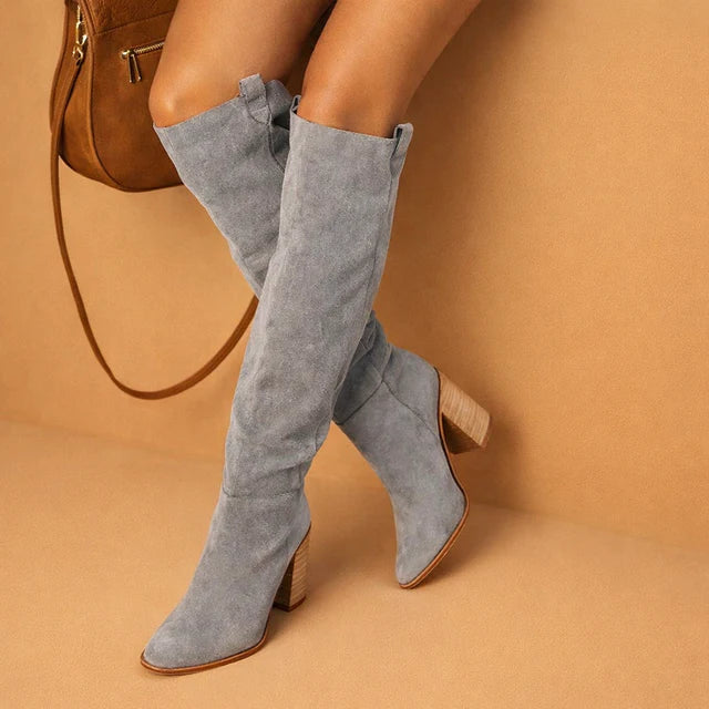 Women's stylish over-the-knee boots: Western design, stiletto heel, pointed toe for modern fall looks.
