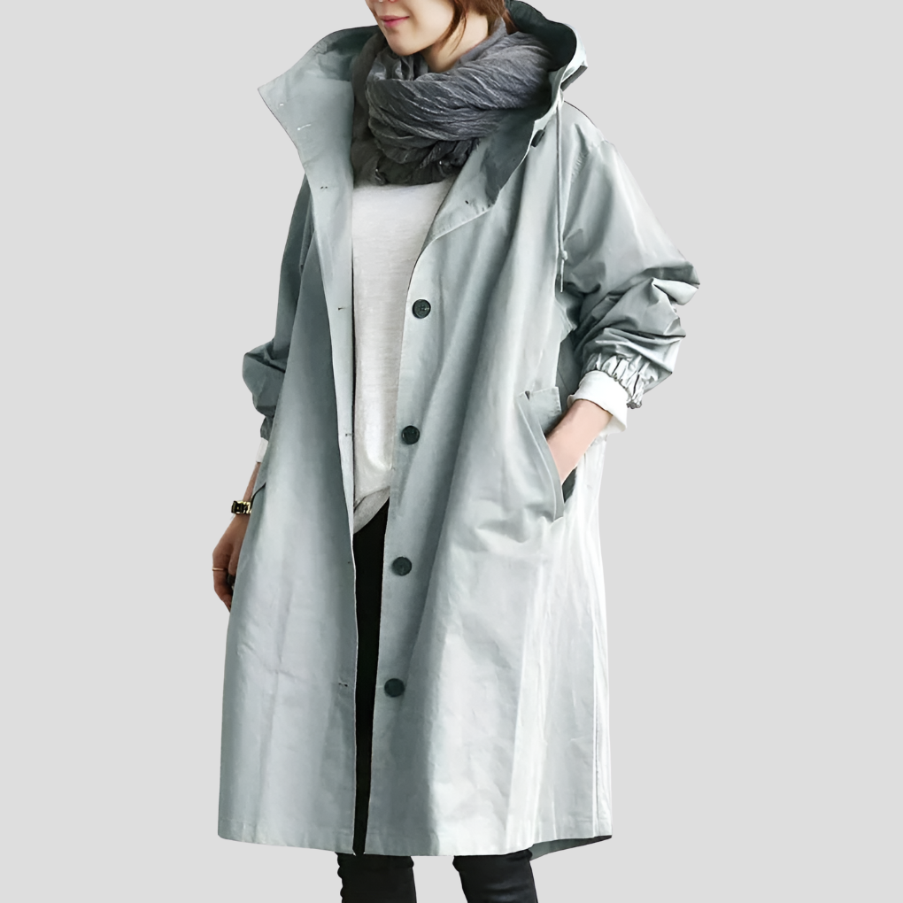 Waterproof women's oversized raincoat with hood. All-season outerwear, offering stylish protection from rain.