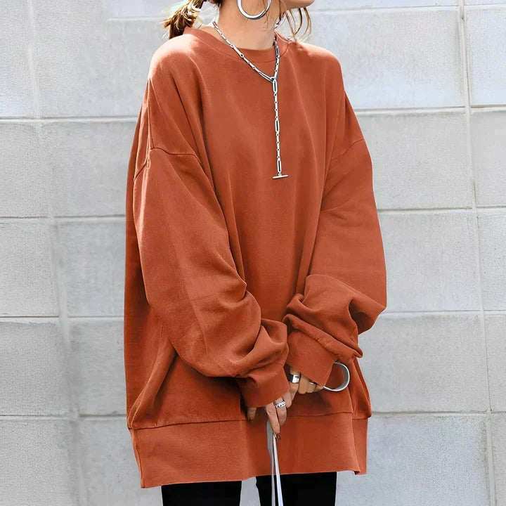 Elegant women's oversized drop shoulder tunic sweater. Soft knit fabric, long sleeve crewneck for stylish casual wear.