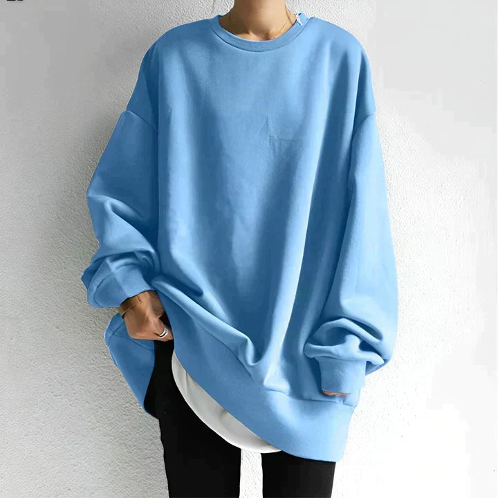Women's cozy oversized tunic sweater with drop shoulder design. Stylish long sleeve knit, ideal for fall/winter comfort.