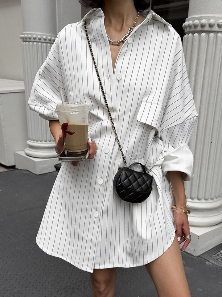 Stylish women's oversized white striped shirt dress with a relaxed fit, perfect for casual chic everyday wear.