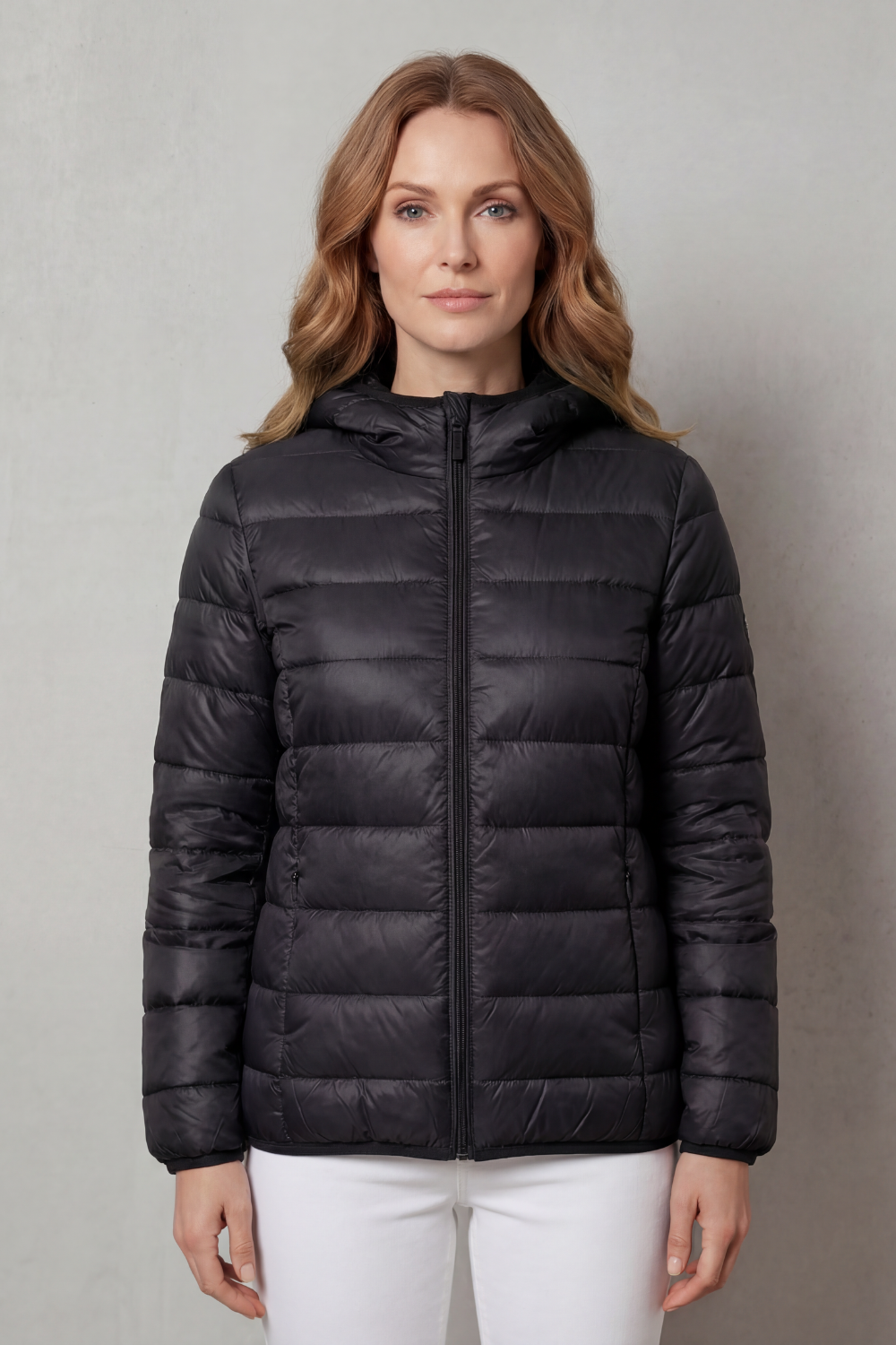 Side profile of a gray women's stylish waterproof rain jacket for layering.