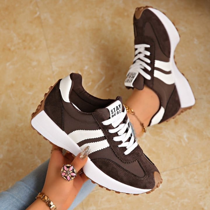 Side view of women's fashion sneakers with a high retro platform sole, offering athletic casual style.