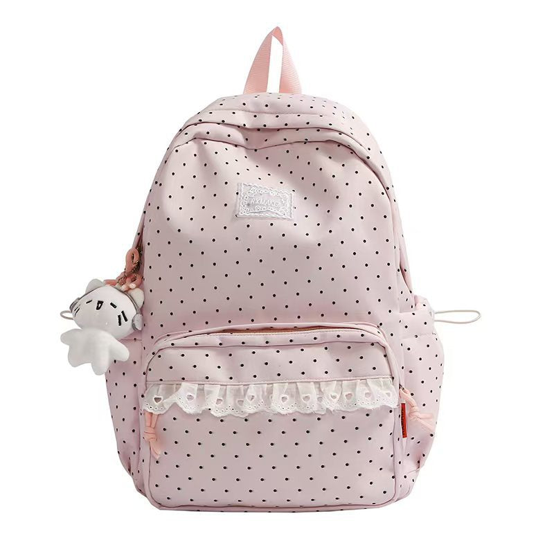 Chic women's polka dot backpack featuring elegant ruffles, a stylish accessory for travel or everyday use.