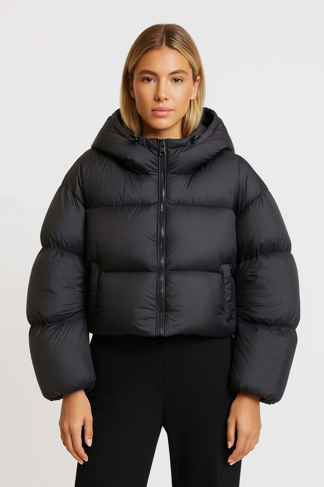 Cozy women's short hooded puffer jacket offers warm, protective insulation for stylish winter outerwear.