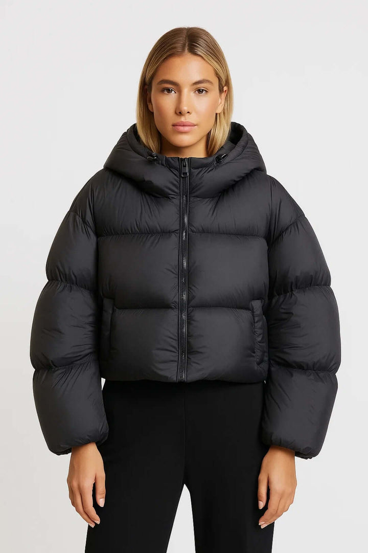 Cozy women's short hooded puffer jacket offers warm, protective insulation for stylish winter outerwear.