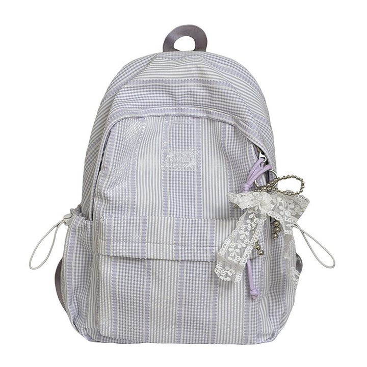 Fashionable women's textured backpack worn on a shoulder, ideal for travel or daily essentials.