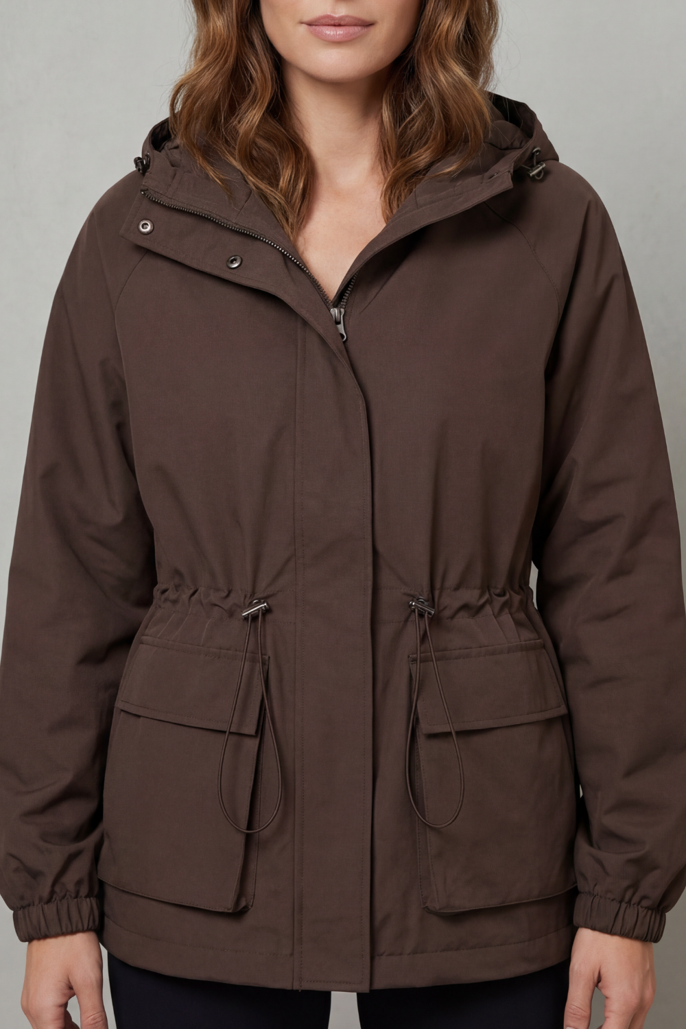 Stylish women's utility waterproof jacket in brown, lightweight with drawstring, ideal for autumn casual wear.