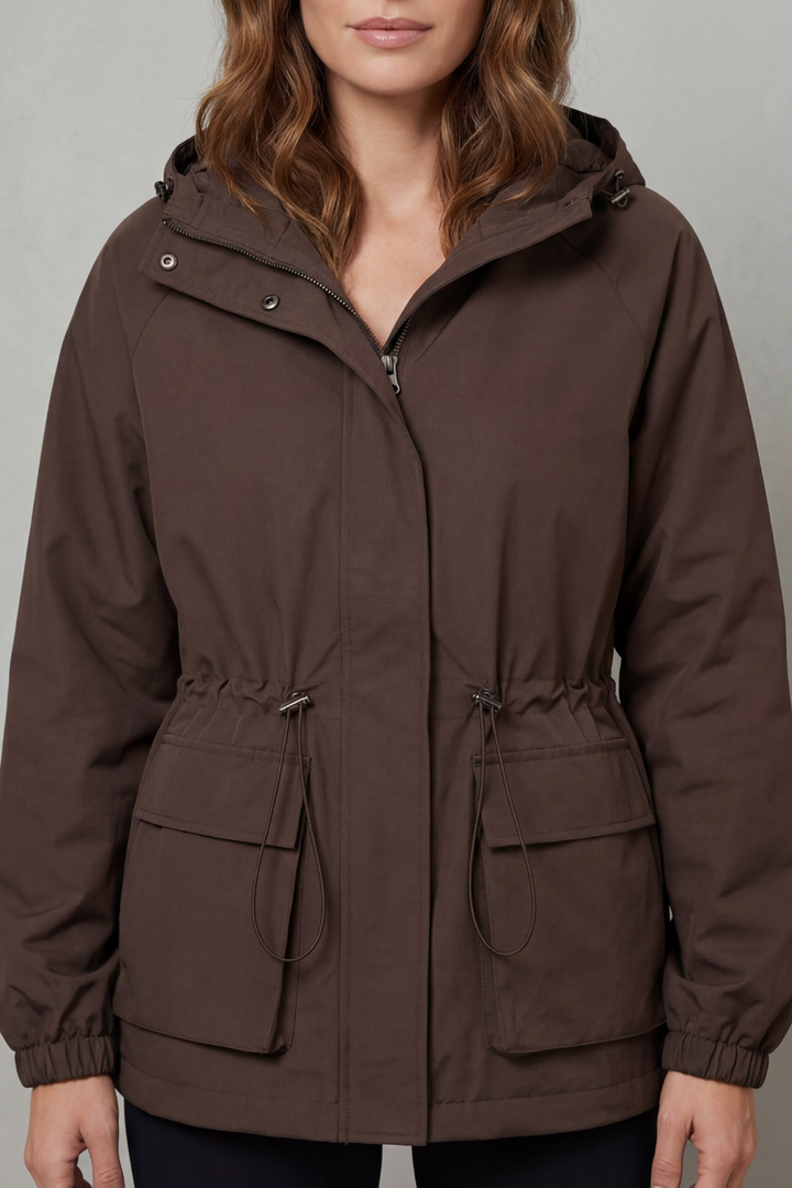 Stylish women's utility waterproof jacket in brown, lightweight with drawstring, ideal for autumn casual wear.