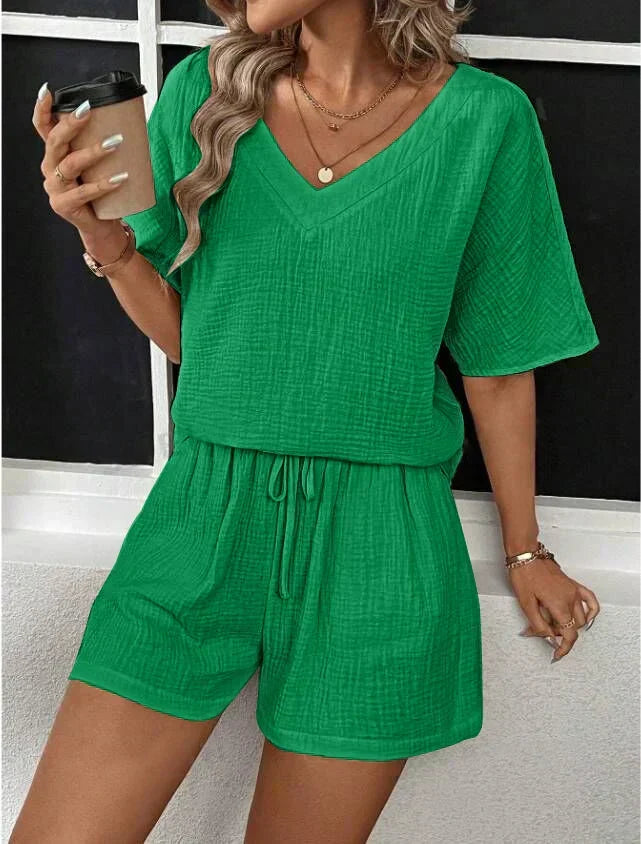 Stylish women's V-neck top and shorts set in a casual chic design, perfect for summer comfort.