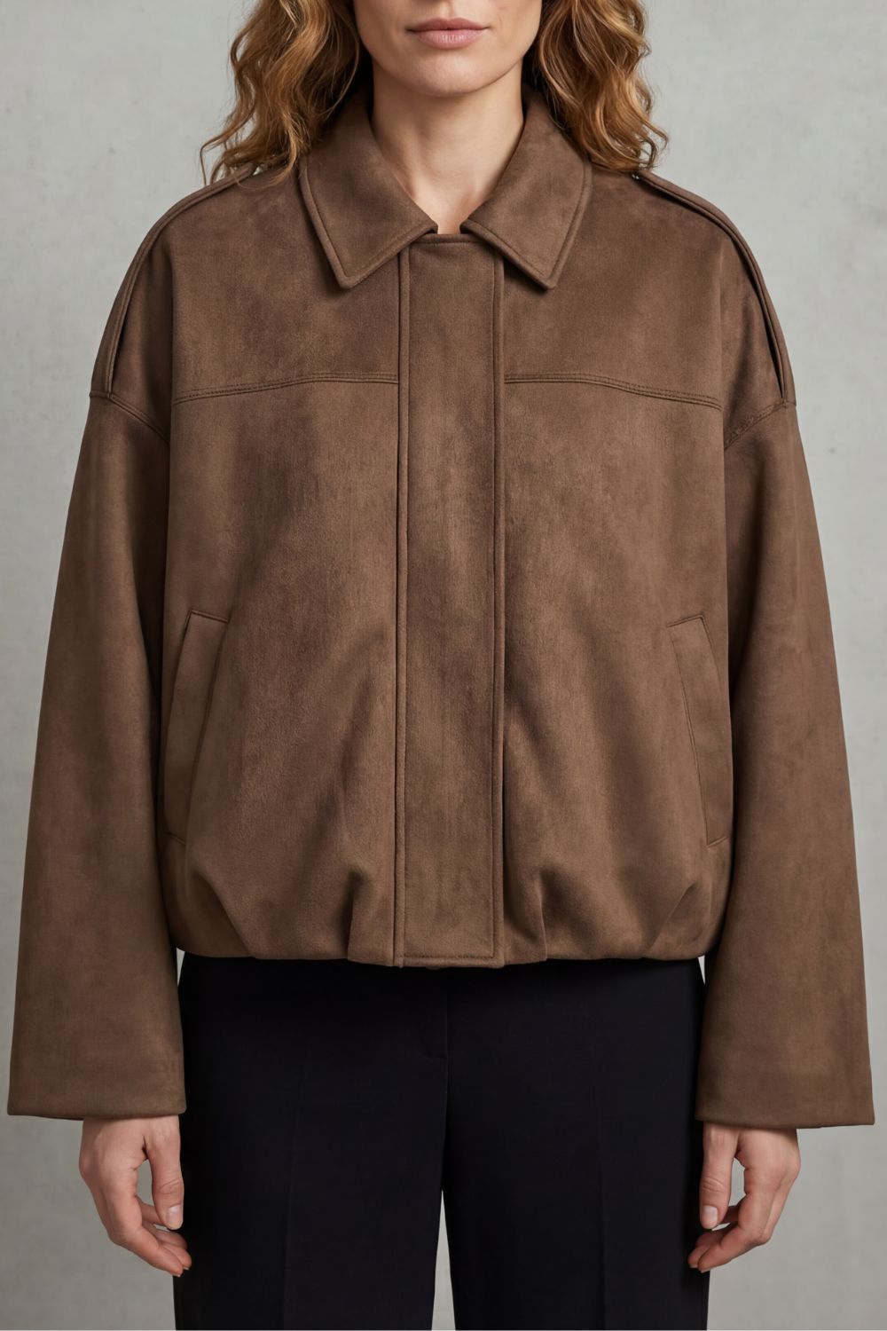 Model wearing a versatile women's volume bomber jacket, paired casually for everyday chic fashion.