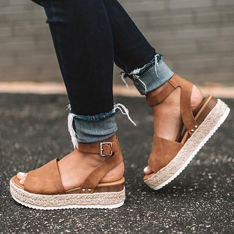 Stylish women's wedge sandals with comfortable ankle strap. Perfect for summer fashion and casual chic looks.