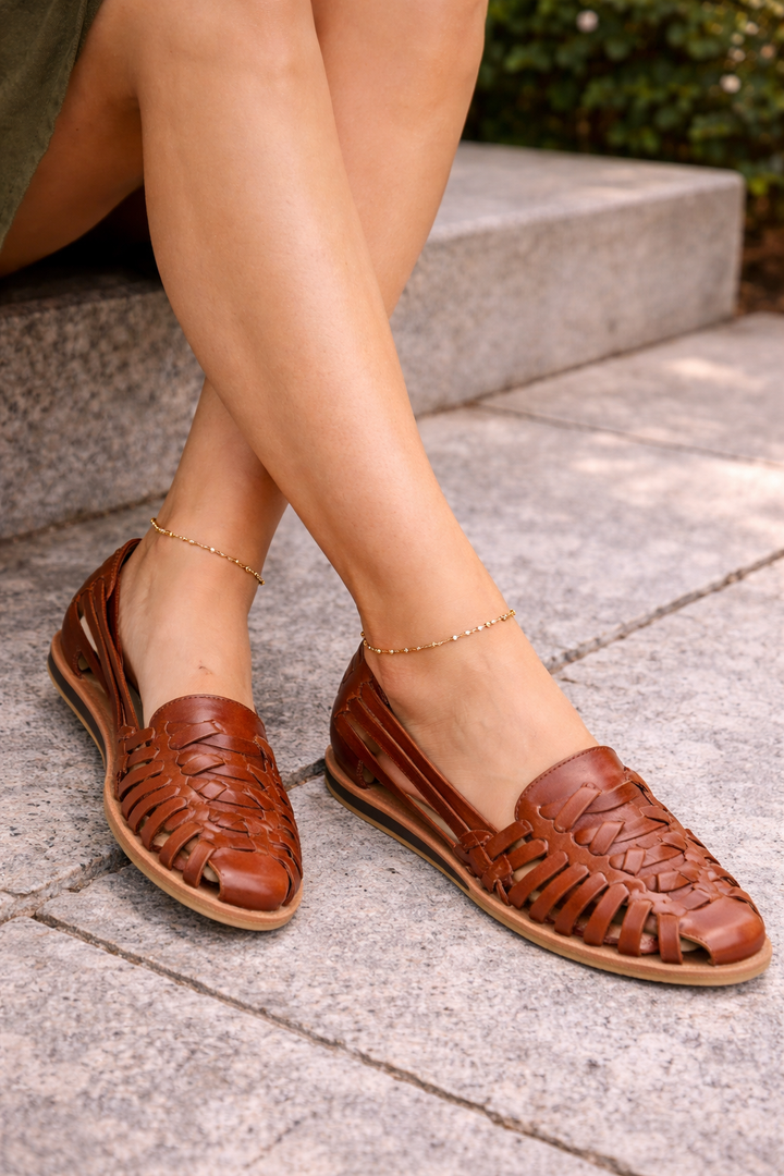 Stylish women's woven leather flat sandals for ultimate summer comfort. Perfect for casual wear & vacations.