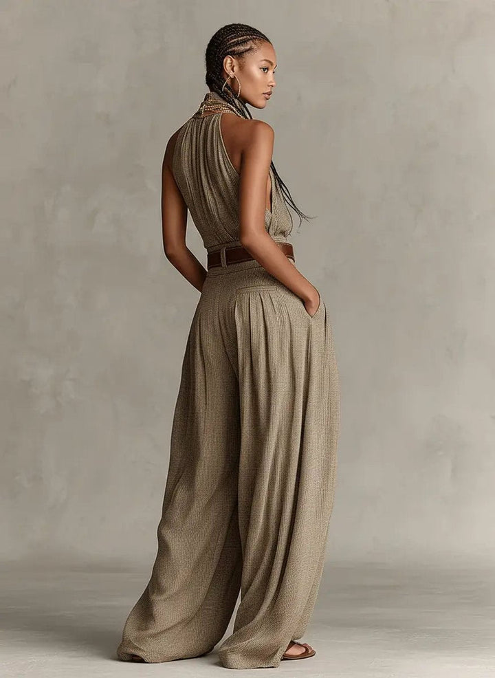 Chic taupe women's halter neck wide-leg jumpsuit, sleeveless and flowing for a relaxed bohemian vacation look.