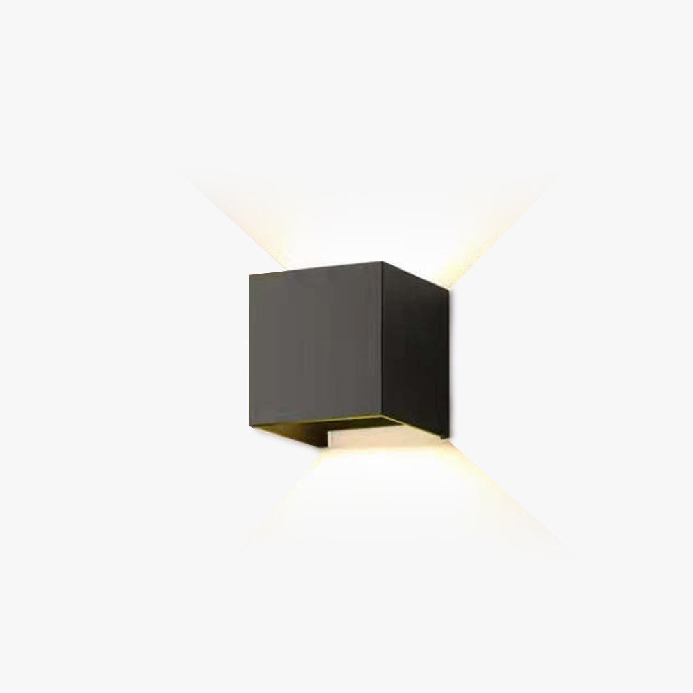 Tavey Modern LED wall light, black finish, illuminating an outdoor patio.