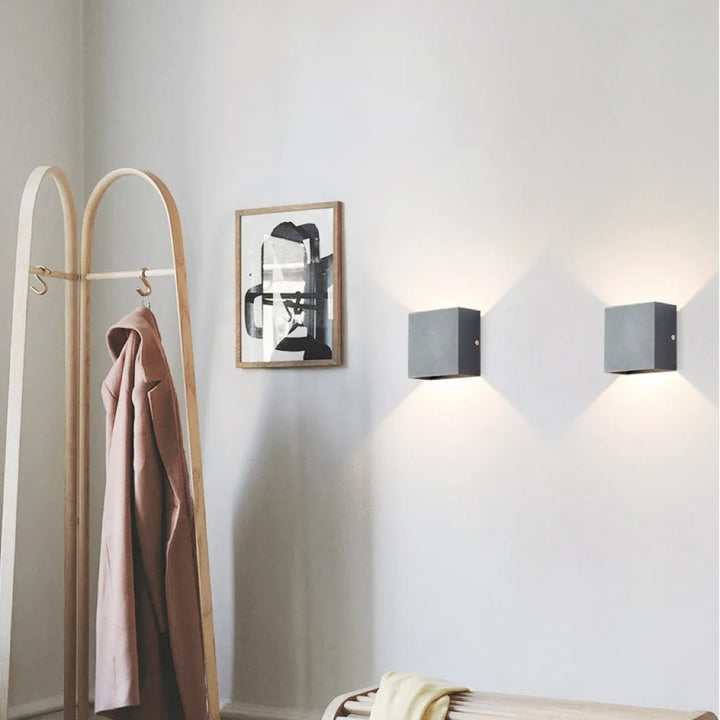 Outdoor Tavey LED patio light, black and modern, creating inviting exterior ambiance.
