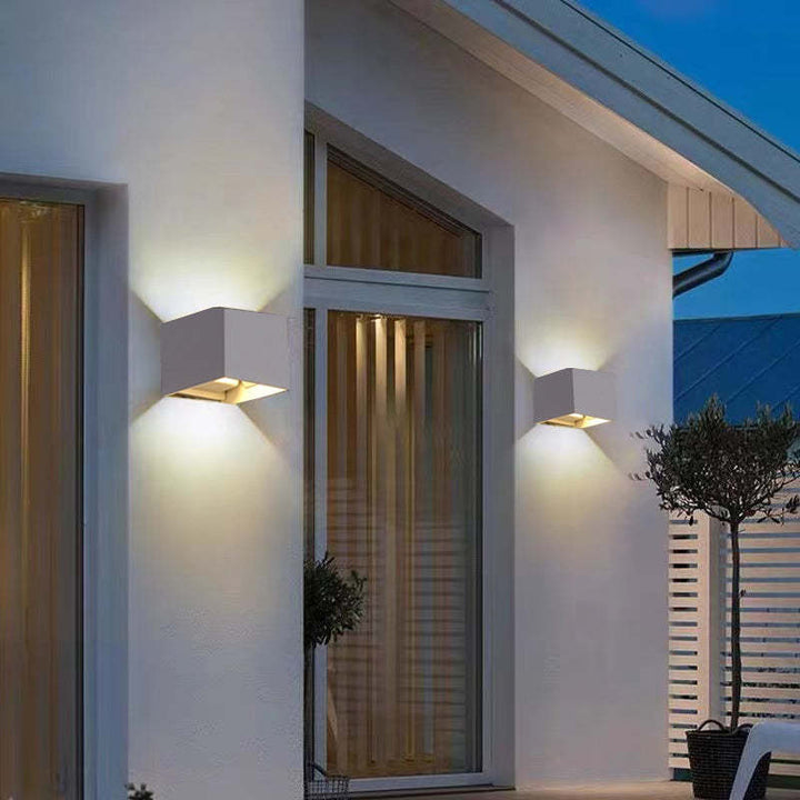 Adjustable Tavey modern LED wall light, sleek black, ideal for indoor/outdoor use.