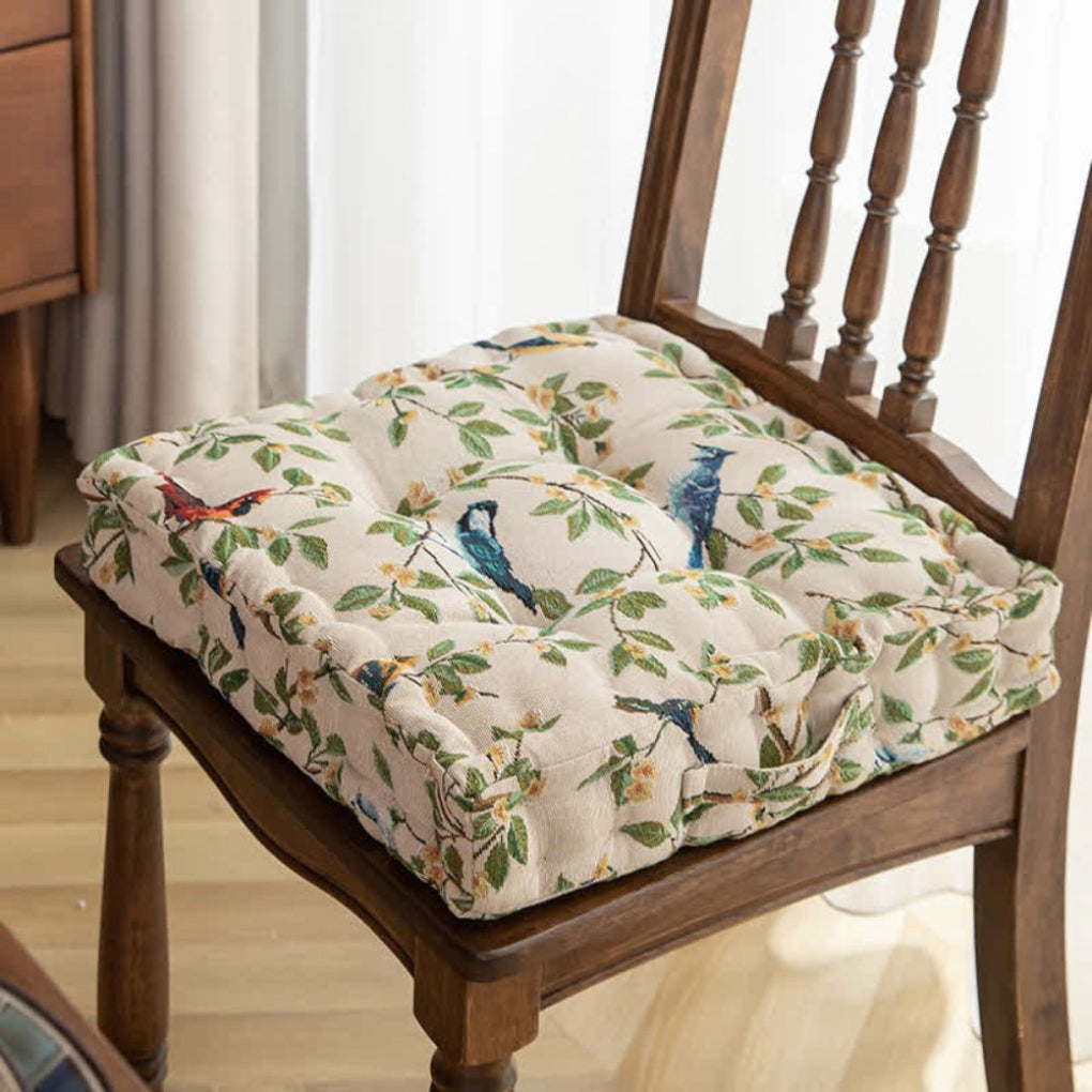 Thick padded square seat pad with ties, perfect for dining or patio chairs, featuring a stylish bird leaf pattern.