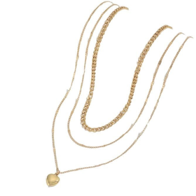 Chic triple layered gold chain necklace for women, featuring a delicate heart pendant design.