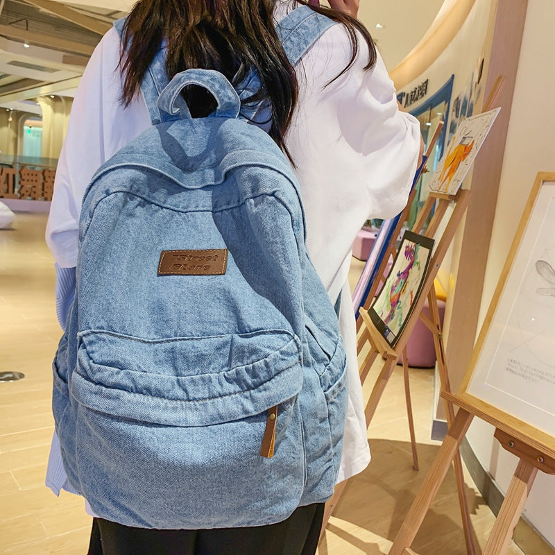 Classic blue denim backpack, unisex design for school and travel, a lightweight & durable student bag.