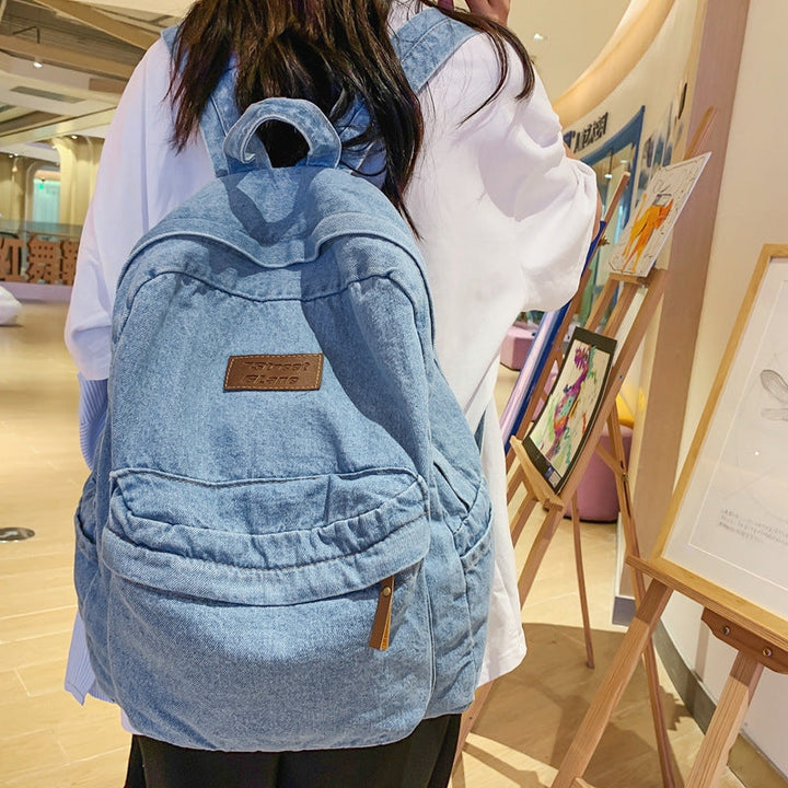 Classic blue denim backpack, unisex design for school and travel, a lightweight & durable student bag.