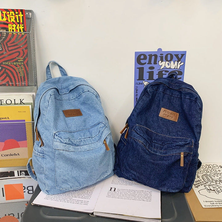Versatile blue denim unisex backpack, great for school, travel, and everyday carry, durable casual style.