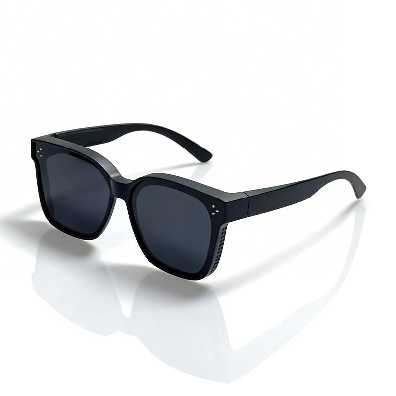 Unisex model wearing bold geometric sunglasses. Modern eyewear providing UV protection and style.