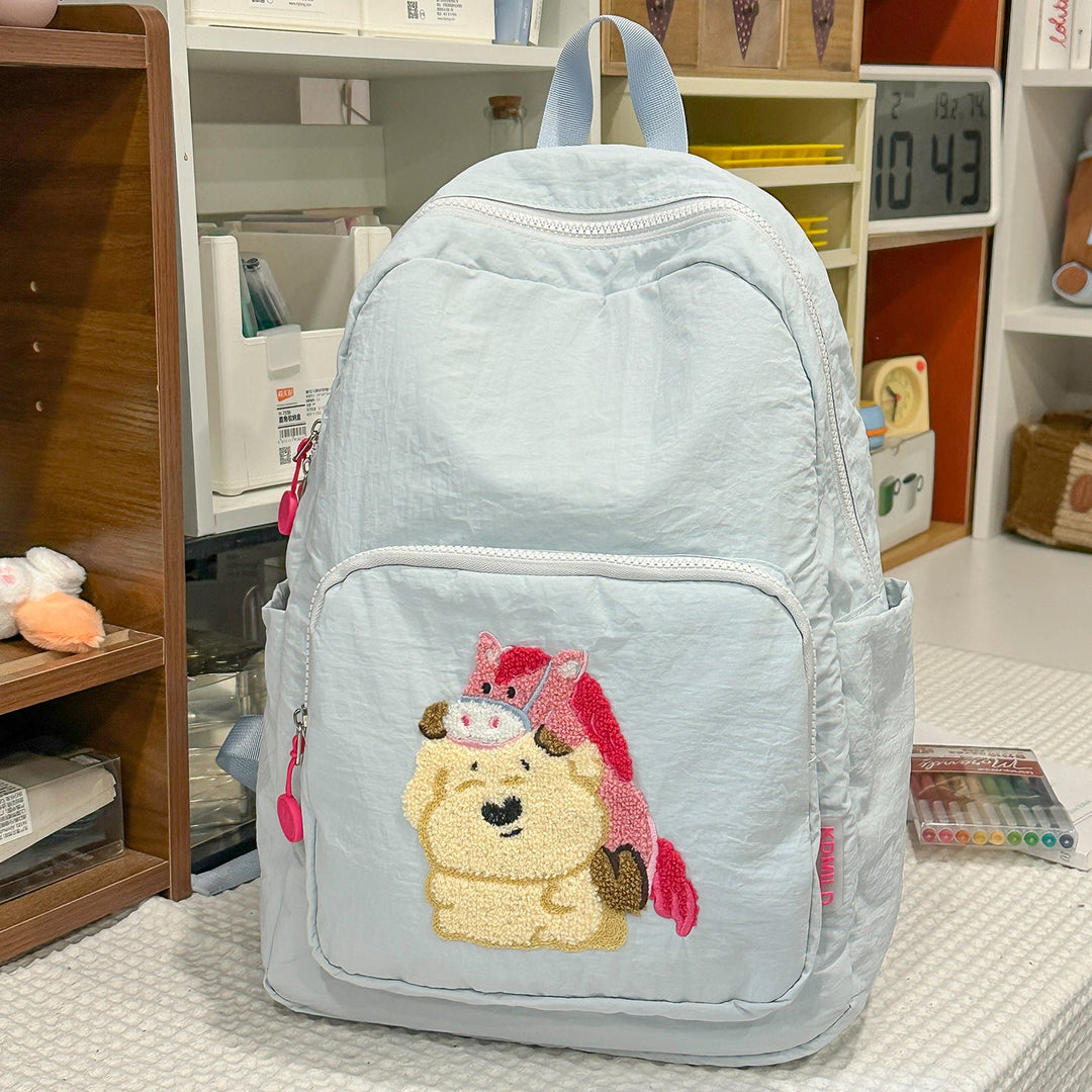 Durable student school bag featuring a vibrant embroidered cartoon character design. Unisex and practical.